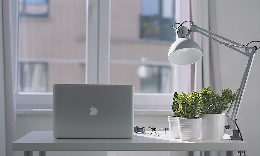 Laptop with the lamp on the desk in the day light