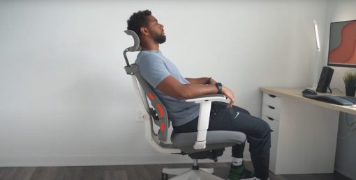 Man sitting on the ergonomic chair. Proper posture Man sitting on the ergonomic chair. Proper posture