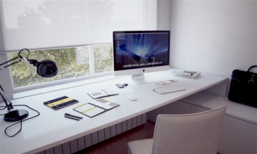 iMac on the desk in front of window iMac on the desk in front of window